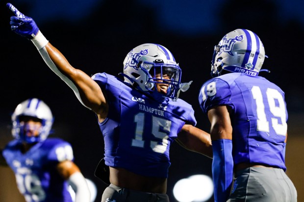 Hampton's Xavier Marshall, left, celebrates with teammate Byron Perkins after Perkins intercepted a pass against Norfolk State on Sept. 9. (Billy Schuerman / The Virginian-Pilot)