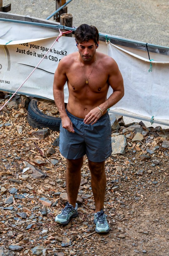 James Argent wearing blue shorts walking during a workout