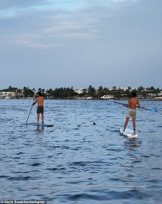 The 44-year-old CAA Fashion model - who boasts 35.1M social media followers - posted a rare picture of her 14-year-old son Benjamin Rein Brady (R) paddleboarding with her boyfriend Joaquim Valente (L), who were pictured wearing the same exact shorts on June 17