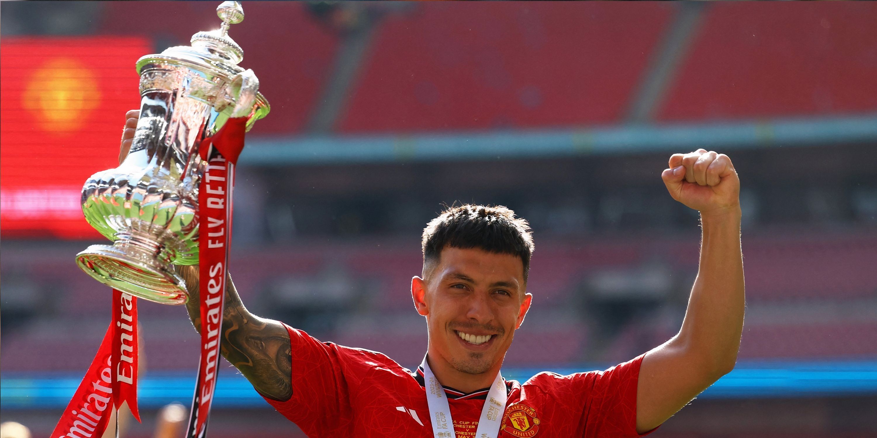 Manchester United's Lisandro Martinez lifts the FA Cup in 2024.