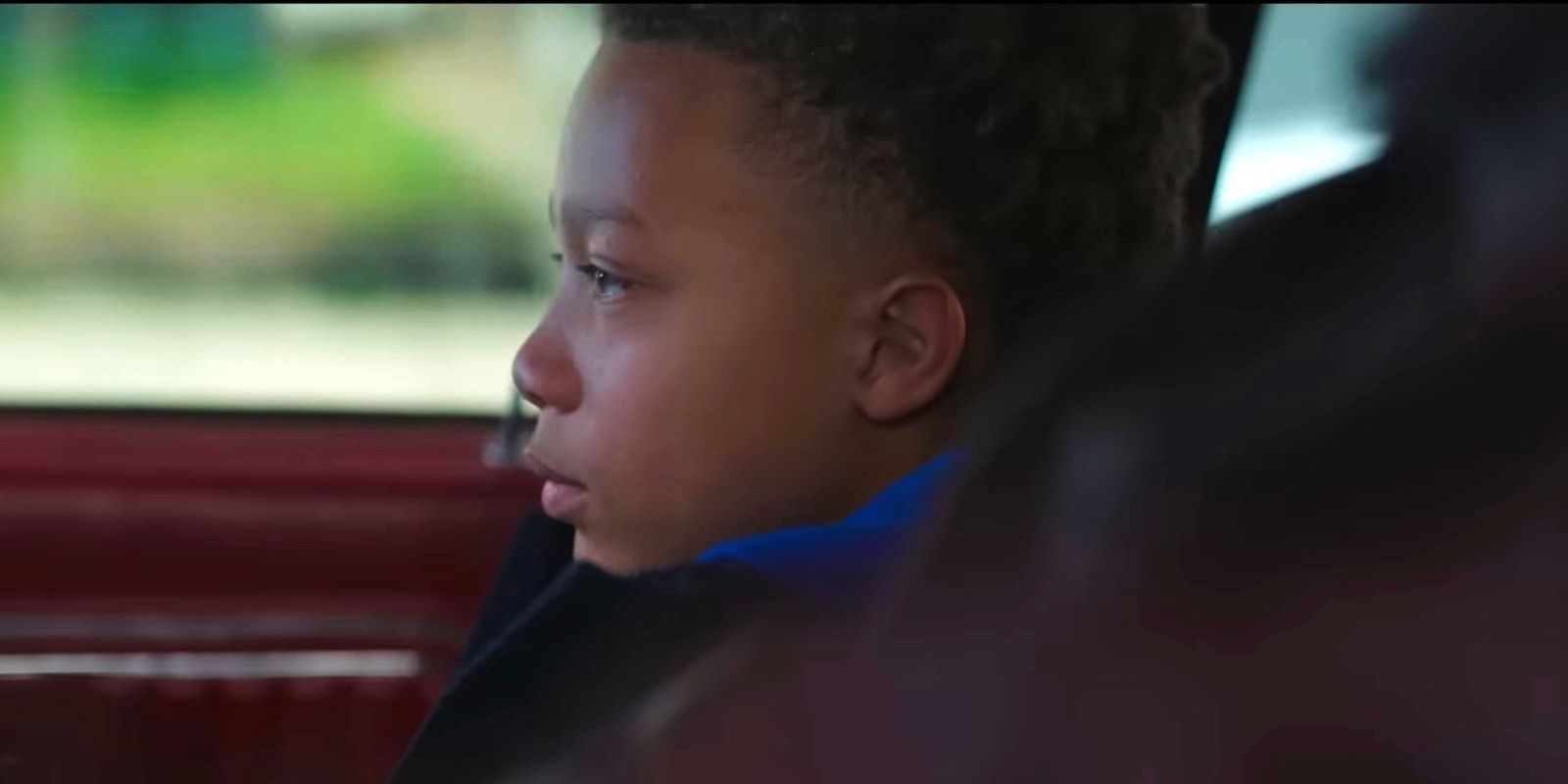 Absolution Liam Neeson grandson sitting in the car looking forward