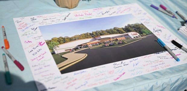 People were encouraged to sign a picture during a groundbreaking...