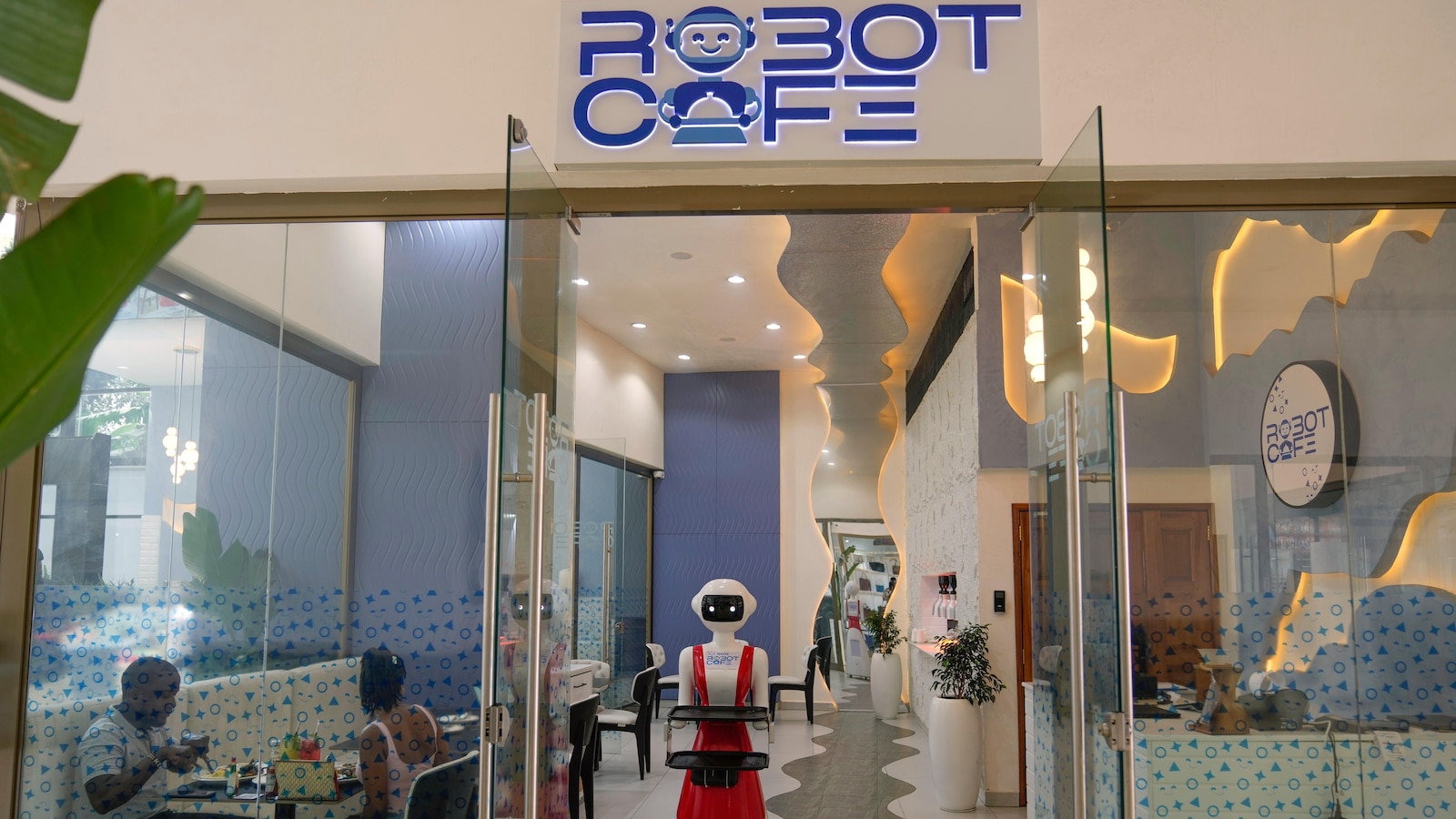 Robot waiters in Kenya create a buzz. But there are concerns about what it means for human labor