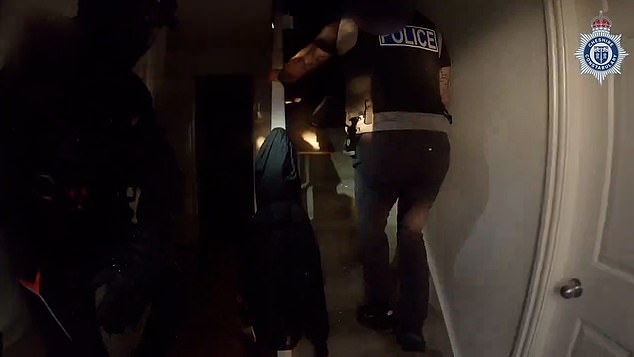 Cops appear to have woken him from his slumber after they smashed through the door and thundered up the stairs