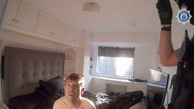 The dejected dealer has been cuffed by a masked officer, and appears sadly acceptant as he sits alone on his bed after his crimes have been read out