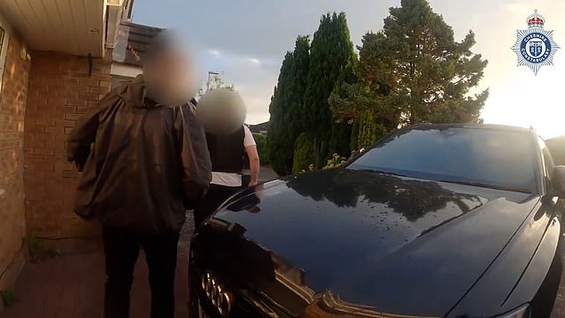 In footage of his arrest, cops can be seen smashing through his dront door in a daring morning raid
