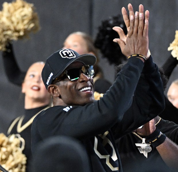 Colorado head coach Deion Sanders looks up to the crowd...