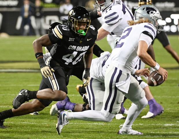 Colorado's Taje McCoy chases Kansas State quarterback Avery Johnson at...