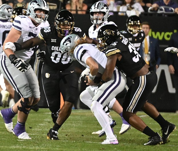 Colorado's BJ Green II (right) and Amari McNeill sack Kansas...