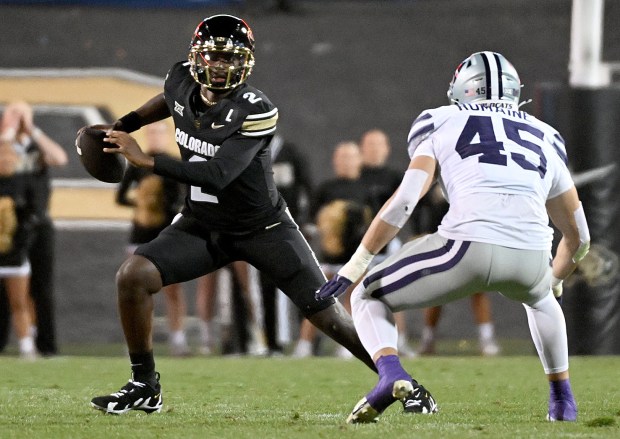 Colorado quarterback Shedeur Sanders looks for an open receiver against...