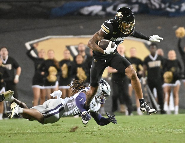 Colorado's Will Sheppard, right, tries to escape from Kansas State's...