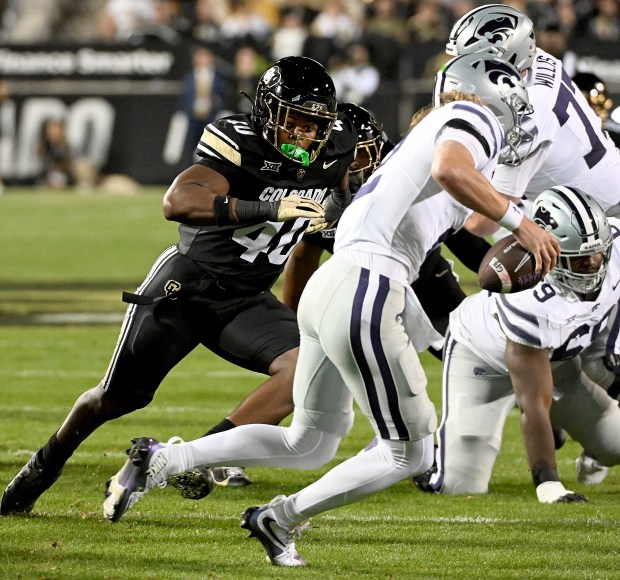Colorado defensive end Taje McCoy chases Kansas State quarterback Avery...