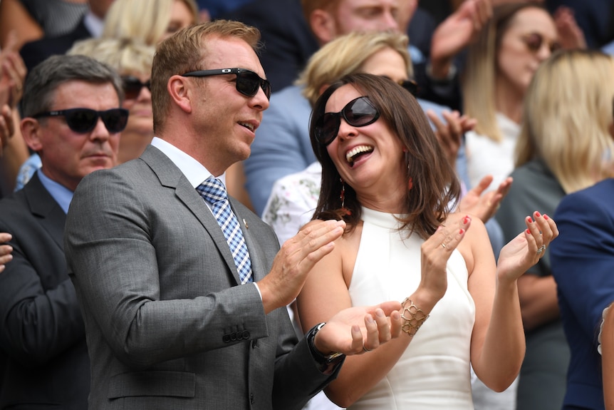 Sir Chris Hoy claps as Sarra Kemp smiles at him