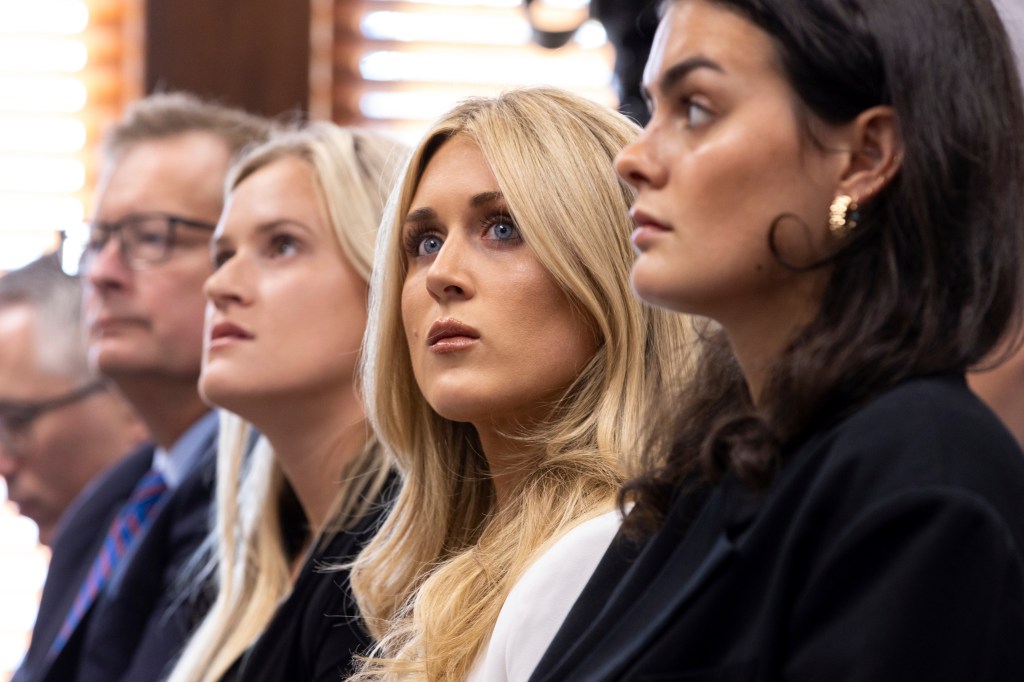 Former collegiate swimmers Kaitlynn Wheeler, from third left, Riley Gaines, and Grace Countie, who competed in Georgia but aren't from the state, prepare to testify in opposition to transgender athletes in women's sports in front of the state senate's Special Committee on Protecting Women's Sports at the Capitol in Atlanta, Tuesday, Aug. 27, 2024. (Arvin Temkar/Atlanta Journal-Constitution via AP)
