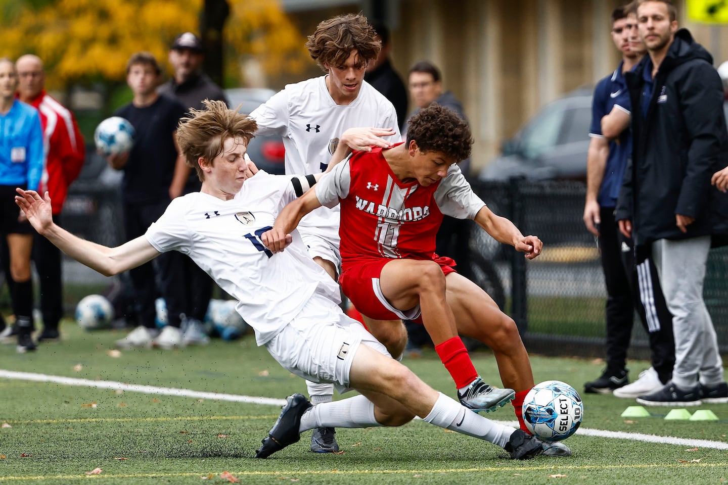 Lexington's Leonas Schmidt makes a sliding tackle on Wakefield's Alex De Morais during Monday's game.