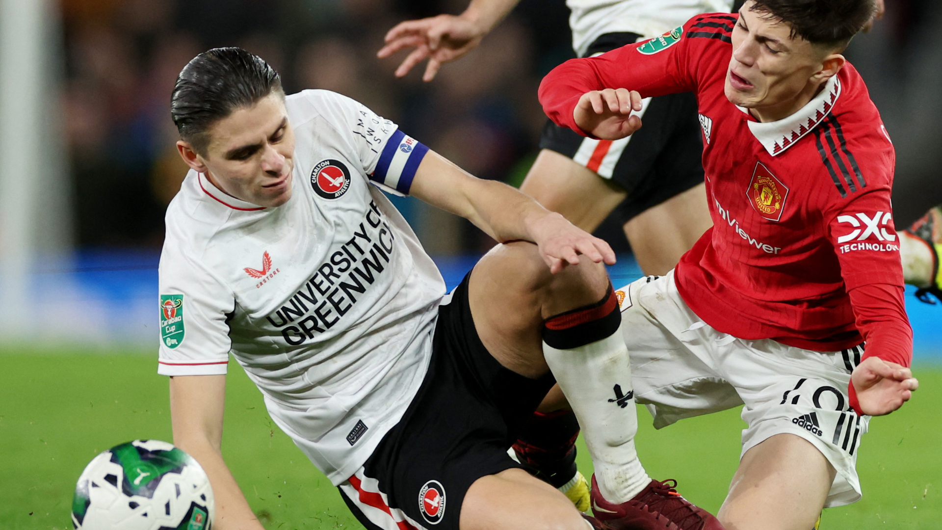 Charlton's George Dobson tackles Manchester United's Alejandro Garnacho