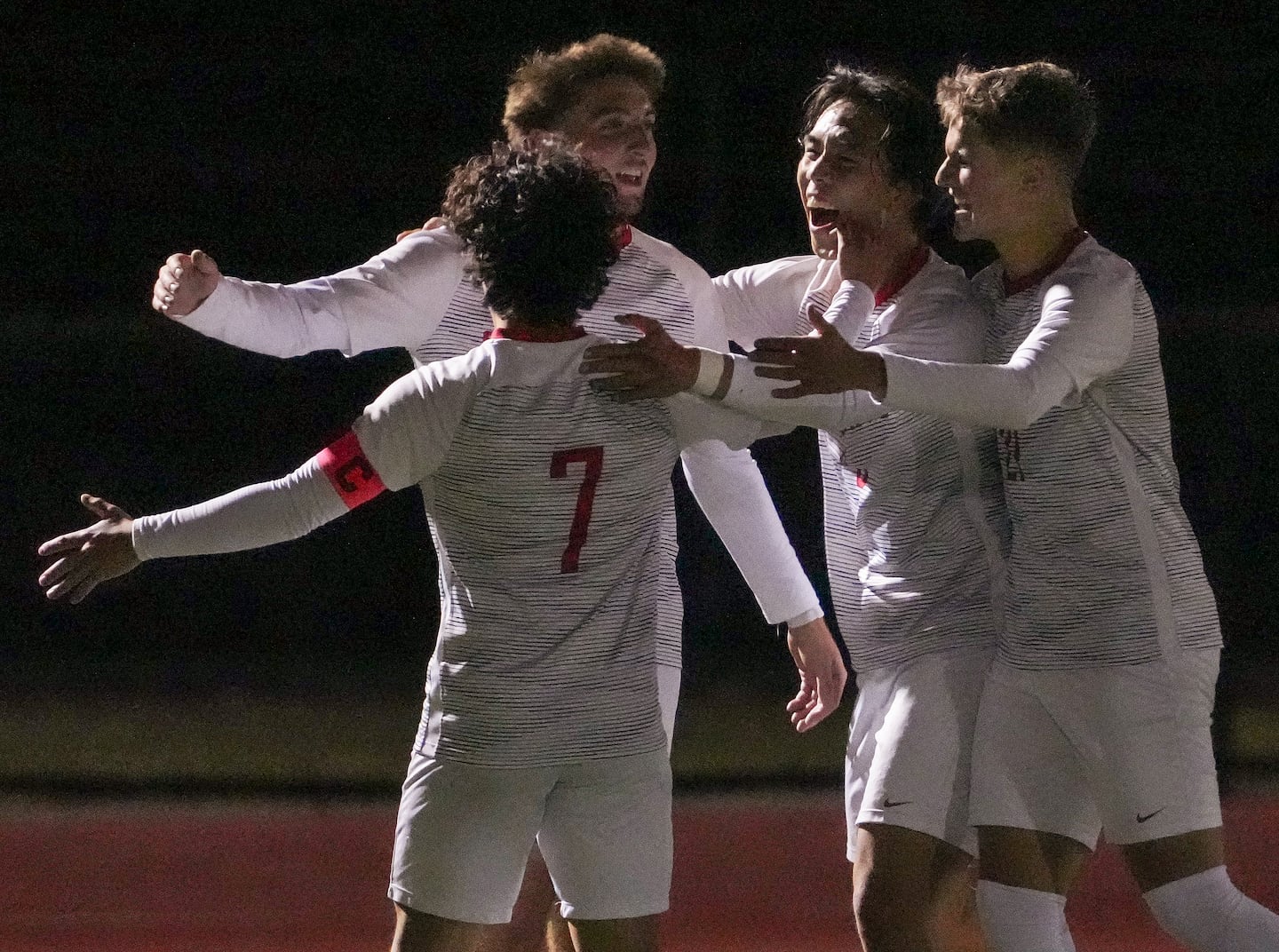Will Baltas is joined by St. John's (Shrewsbury) teammates after scoring the go-ahead goal. 